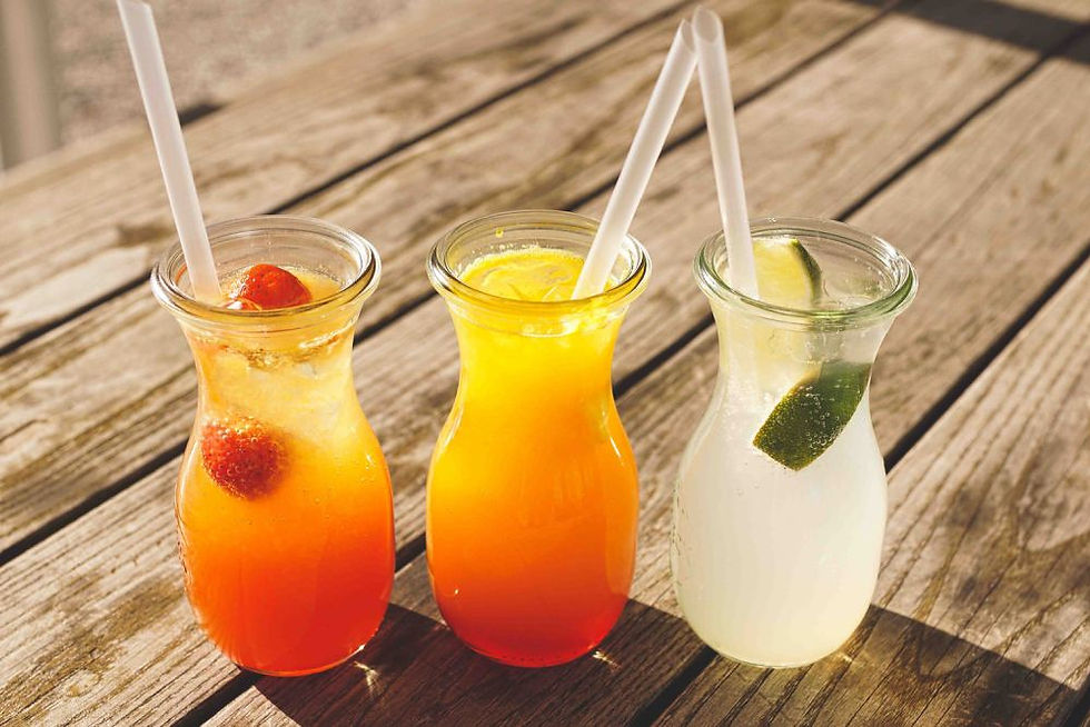 Three summery drinks on an wooden table