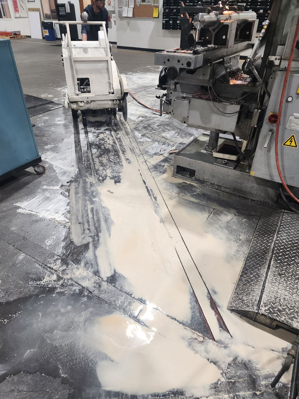 Running the saw inside with water to keep the dust down.