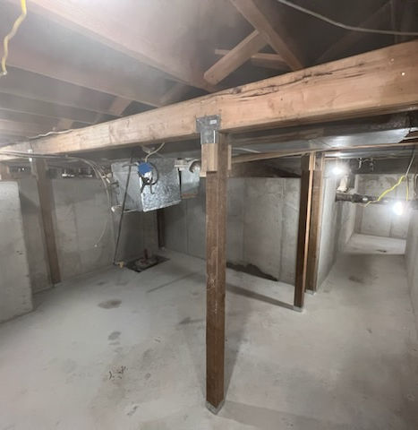This is the finished concrete furnace room in the basement. With new beams and home support.