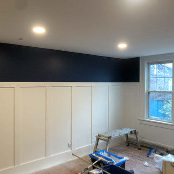 new navy blue painted walls and white wainscoting trim in newly remodeled house in Glastonbury CT