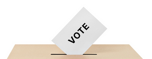 vote being inserted in a ballot box