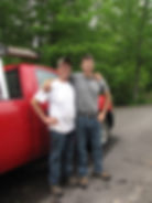 Aaron Russ and his father Earl Russ standing in front of a red work truck, representing the multi-generational legacy behind Russ Home Improvements in Connecticut