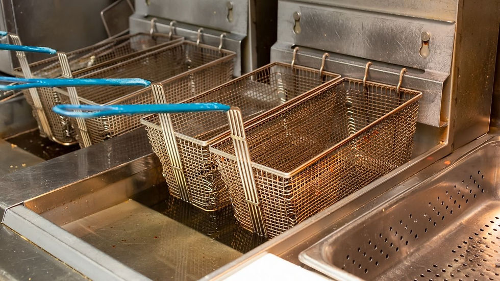 commercial deep fryer baskets in restaurant kitchen generating used cooking oil for recycling and collection services