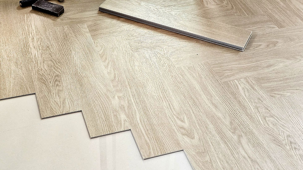 light wood EVP flooring being installed in a herringbone pattern on a clean white subfloor