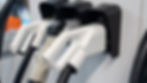 close-up of electric vehicle charging plugs at a charging station.