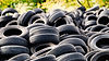 lot of used tires all piled up on a lot