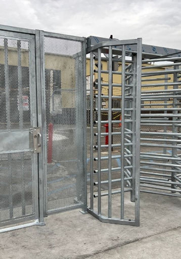 galvanized full height turnstile and secure pedestrian gate providing controlled access at an industrial facility