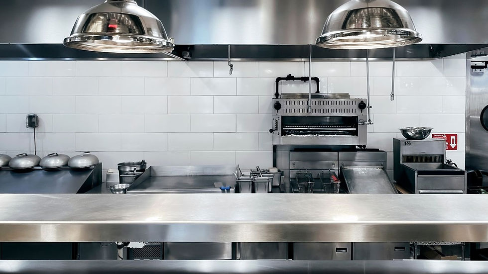 clean commercial kitchen with stainless steel equipment and deep fryers ready for cooking oil use