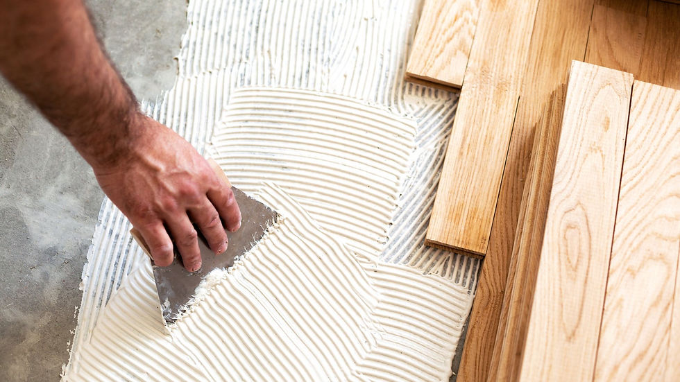 installing hardwood flooring with adhesive using trowel on subfloor for wood floor installation