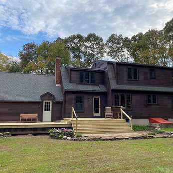 Finished exterior painting project and deck build of colonial house in brown stain in Andover CT