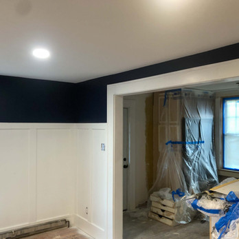 new navy blue painted walls and white wainscoting trim in newly remodeled house in Glastonbury CT
