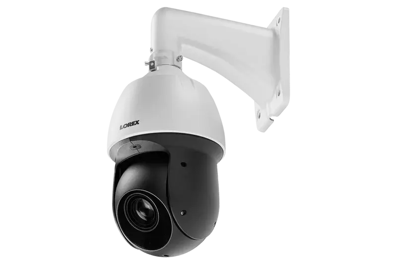 close-up of a white and black PTZ (pan-tilt-zoom) security camera mounted on a white wall bracket.