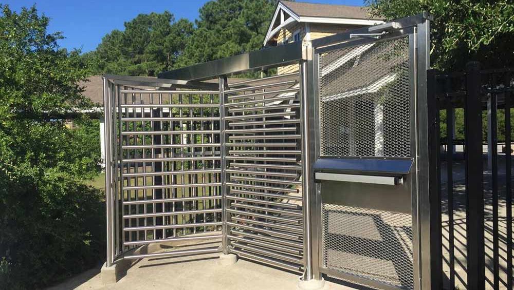 full-height turnstile with a stainless steel mesh design at an entrance.