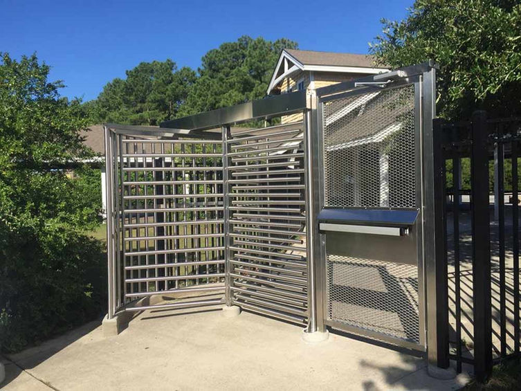 full-height turnstile with a stainless steel mesh design at an entrance.