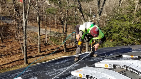 Residential roofing installation in Connecticut by Russ Home Improvements, featuring underlayment and a roofer in safety gear