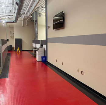 Finished accent wall with grey strip on repaired drywall in commercial office space located in Rhode Island 