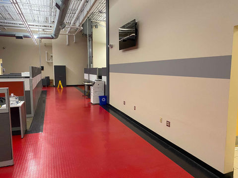 Finished accent wall with grey strip on repaired drywall in commercial office space located in Rhode Island