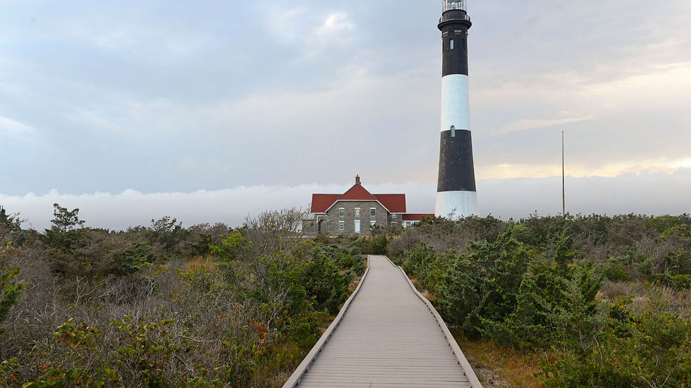 Boardwalk leading to Fire Island Lighthouse in Suffolk County NY surrounded by natural landscape, symbolizing Olson Floor Supply’s commitment to quality flooring in Long Island’s coastal communities.