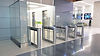 optical turnstiles installed in a modern office lobby providing secure access control with glass barriers and electronic entry systems