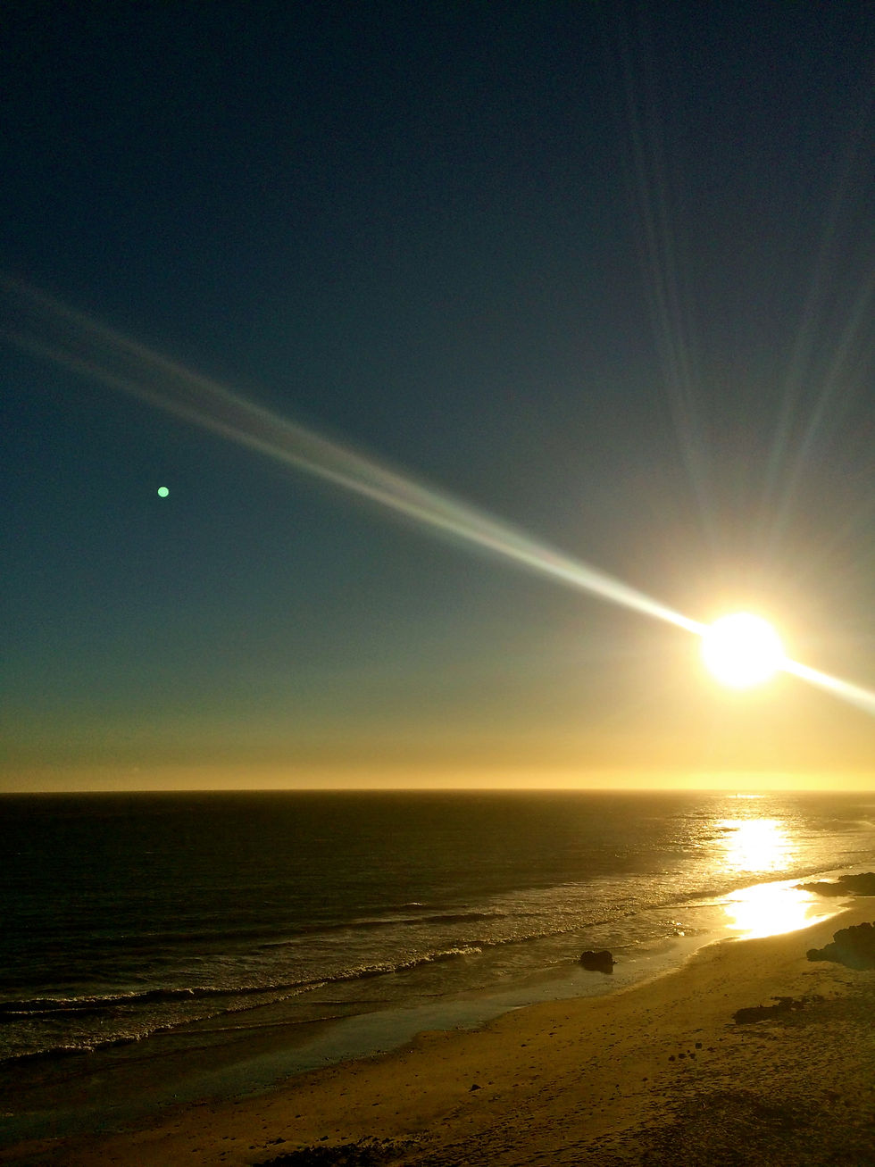 Sun setting over the ocean in Malibu, California