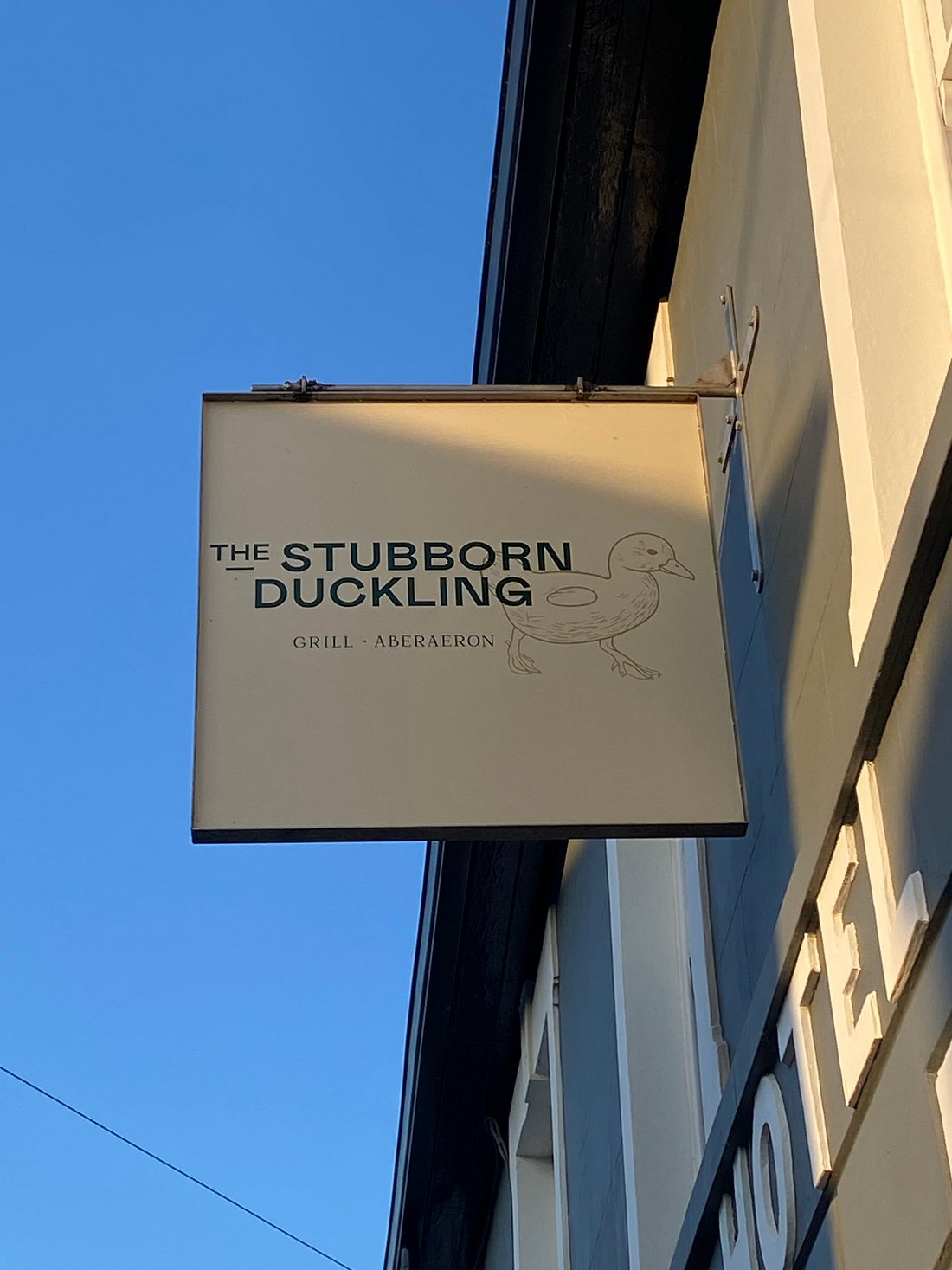 The Stubborn Duckling sign on front of the restaurant