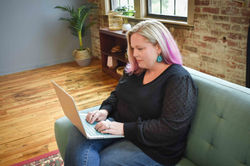 Michelle A. Mercier Typing on Laptop