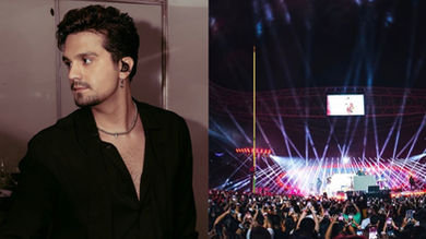 Luan Santana cantando em palco com multidão ao fundo durante show da turnê
