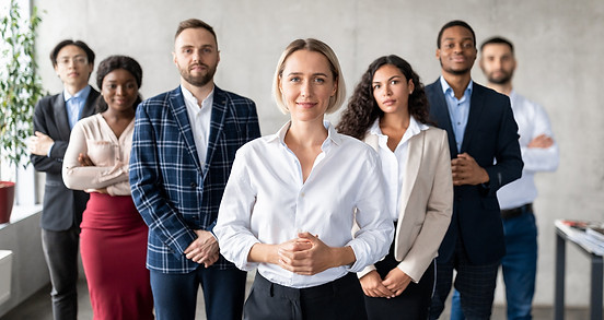 successful-businesswoman-standing-in-front-of-business-team-in-office.jpg