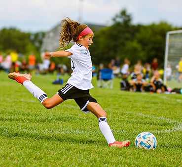 Close-up of a Michigan Stars Lightning player kicking the soccer ball