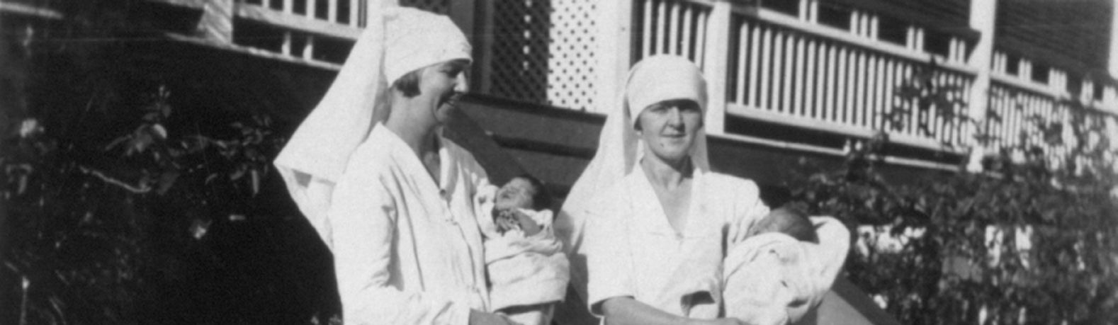 Photo of two nurses holding babies, as part of the Exhibition Block A - Unsung Heroes at the Australian Workers Heritage Centre in Barcaldine