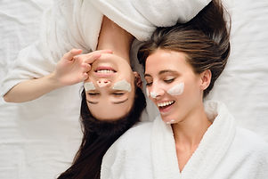 young-smiling-women-in-bathrobes-lying-in-bed-with-2023-11-27-05-03-44-utc.jpg