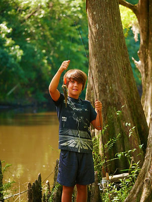 Picture of Jonah Bennett with nice bream © Lee Anne Winchester – Jonah Bennett holds up a nice bream from his fishing hole on Yellow River in Santa Rosa County, Florida, where he pulled in an assortment of fish including a Florida gar.