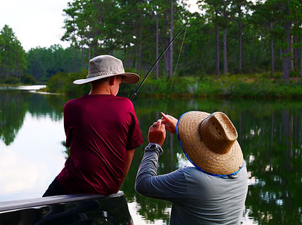 Picture of Duck Pond on Eglin Air Force Base Reservation © Lee Anne Winchester – A father and son sport their fishing hats at Duck Pond on Eglin Air Force Base Reservation in Okaloosa County, Florida. A permit allows conditional use of the reservation for a wide range of recreational activities including access to Eglin's ponds.