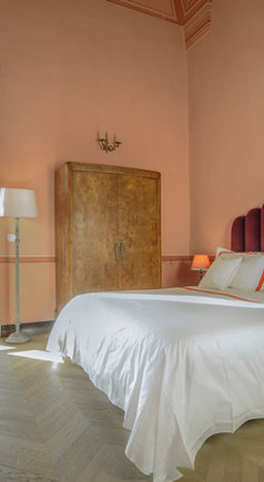 Large hotel room with window and bed.