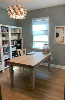 Home Office decorated with desk, wall art, chandelier and bookcases