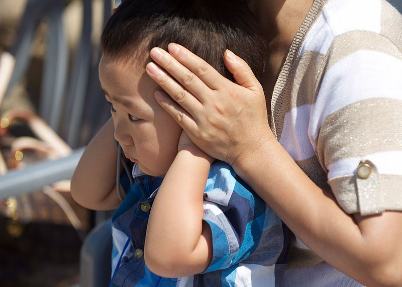 Kid with ears getting covered