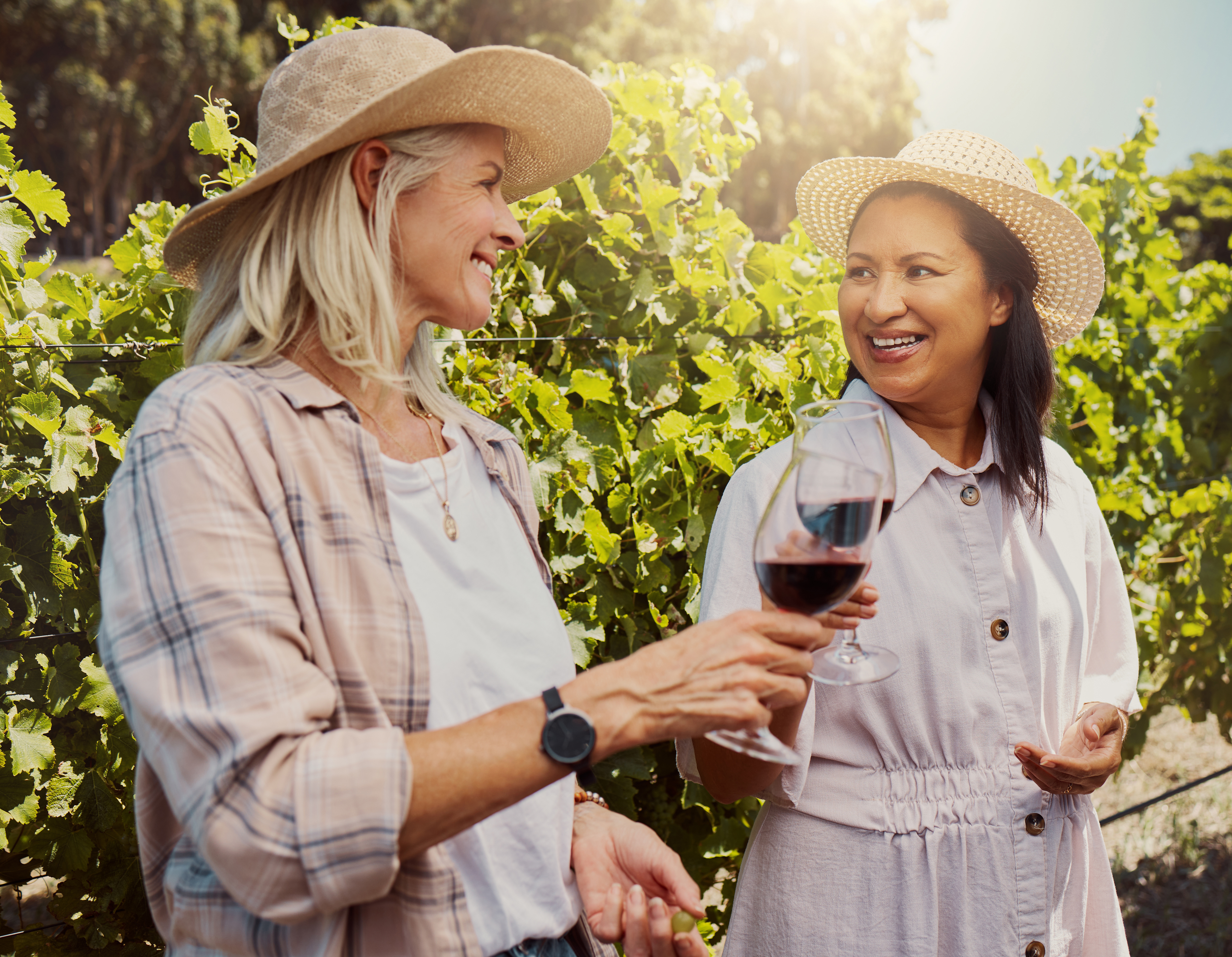 Two women, enjoying wine outside