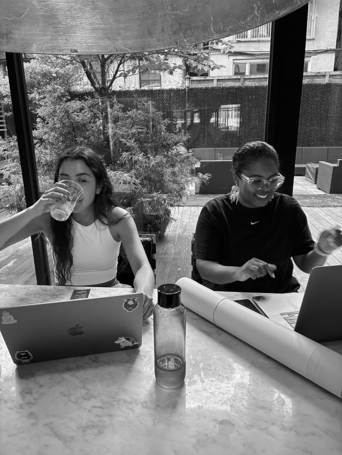A candid, black and white photo of the SCRD team working, celebrating five years of collaborative design from their offices in Baltimore and Brooklyn.