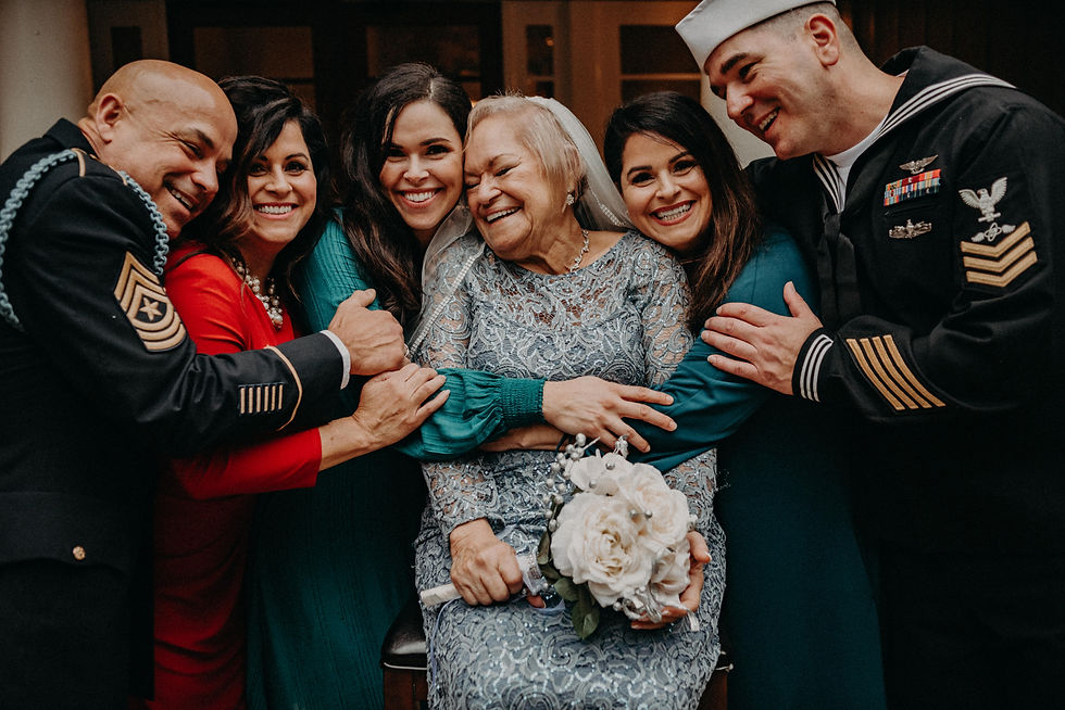 Elder bride hugging her children at her wedding