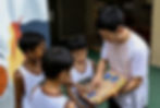Coach showing tactics to kids in Let's Play Basketball