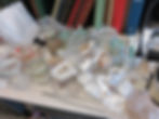 Aerial perspective of sea stars in containers on Chris' desk. Various books are in the background.