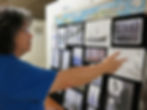 Chris pointing to the Albatross display. Pictures are on a board.