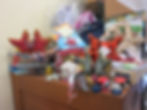 A pile of sea star merchandise on Chris' cabinets. Stuffed animals, toys, and action figures are shown.