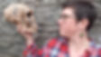 Dr. Rebecca Wragg Sykes looking at a skull.
