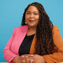 Jessica Esquivel in front of a blue background.