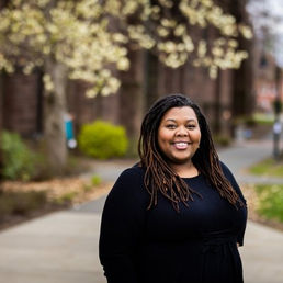 Angelica Patterson in front of trees.