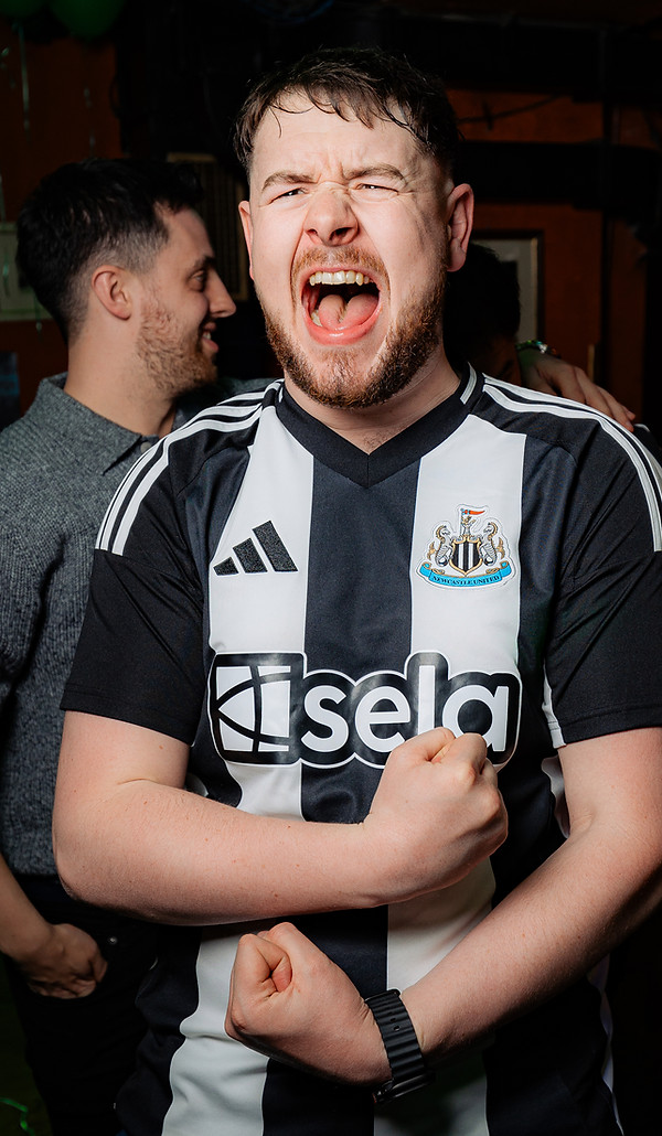 Excited football fan celebrating during live match at Waxy Malone’s Irish pub in Prague