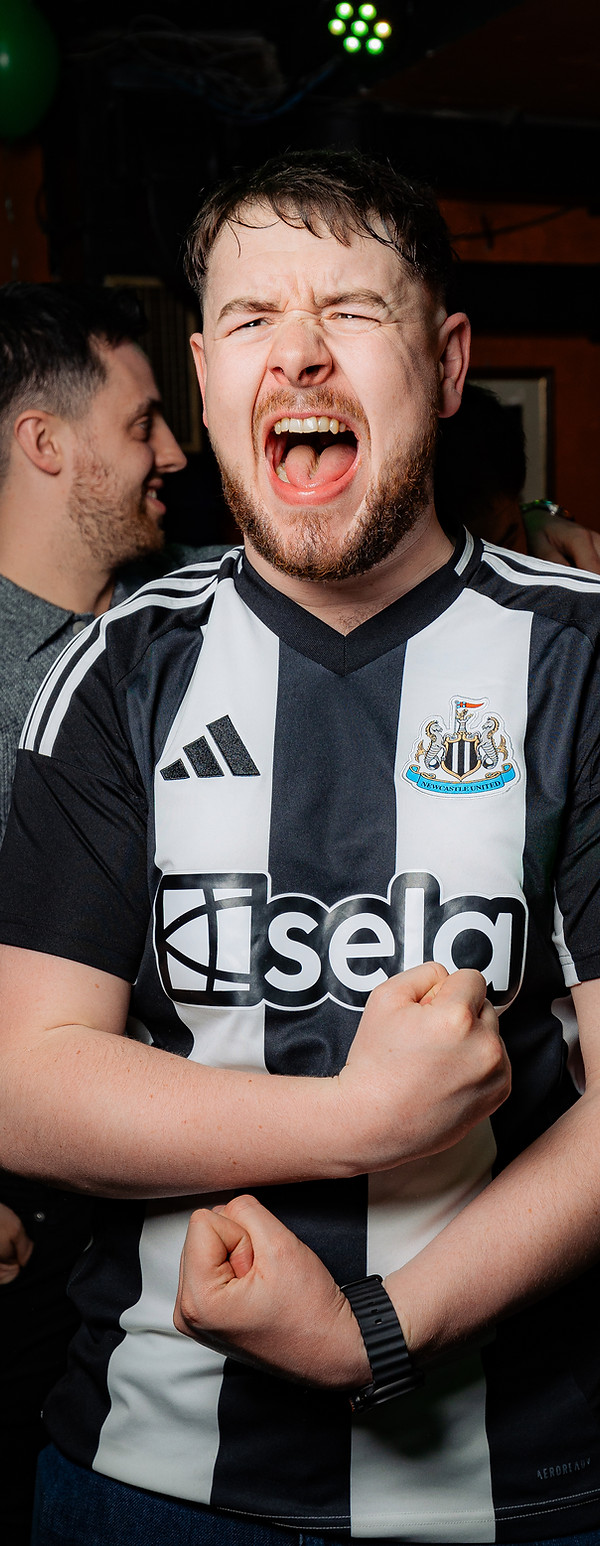 Excited football fan celebrating during live match at Waxy Malone’s Irish pub in Prague