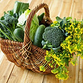 Selection of leafy green vegetables in wicker basket.jpg