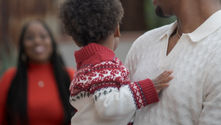 African American Father and Child looking back at a blurred image of the wife and mother.